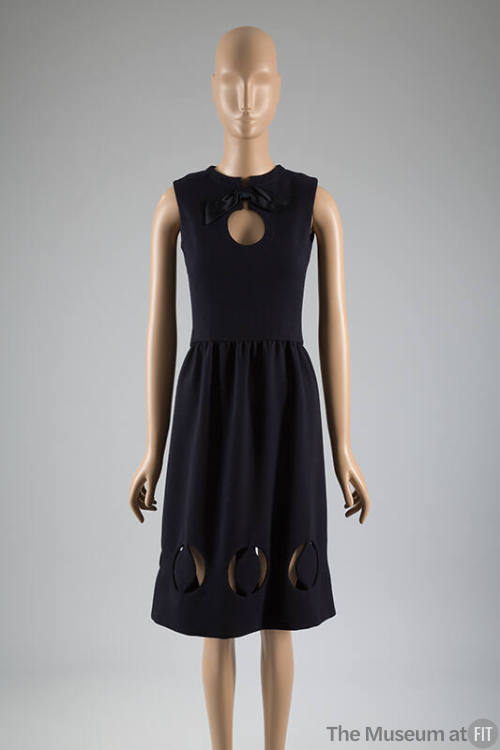 Sleeveless navy blue dress with circular cut outs at neck and hem 