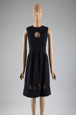 Sleeveless navy blue dress with circular cut outs at neck and hem 