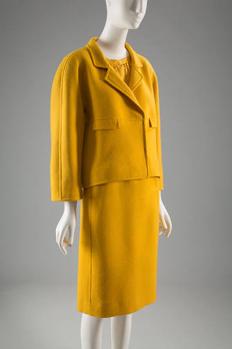 Yellow suit with small notched lapels and knee length straight skirt