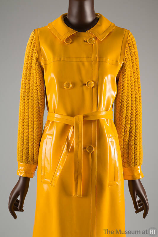 Bright yellow double breasted vinyl coat with matching belt and knit cotton sleeves