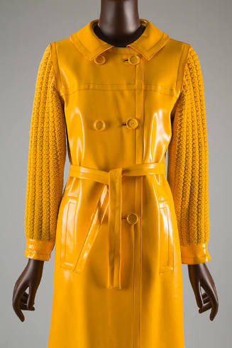 Bright yellow double breasted vinyl coat with matching belt and knit cotton sleeves