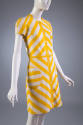 Yellow and white striped short sleeved mini dress with button down front and circular patch poc…