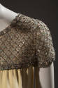 Detail of yellow dress capsleeve embroidered with rhinestones and sequins