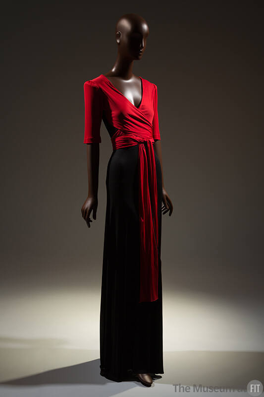 Evening dress: red v-neck top with padded short sleeves, wrap and tie extensions, long black sk…