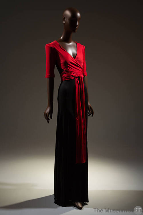 Evening dress: red v-neck top with padded short sleeves, wrap and tie extensions, long black sk…
