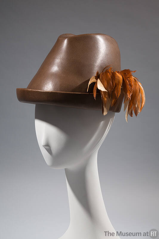 dark brown leather trimmed hat, tan feathers on side