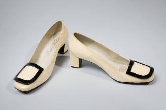 Off white patent leather pumps with black plastic D shaped buckle 