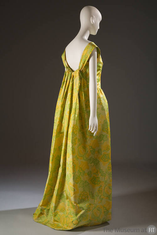 Back view of long evening dress with abstract floral chiné print in shades of green, yellow and…