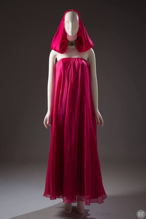 Fuchsia pink strapless floor length evening gown with matching hood tucked into rhinestone neck…