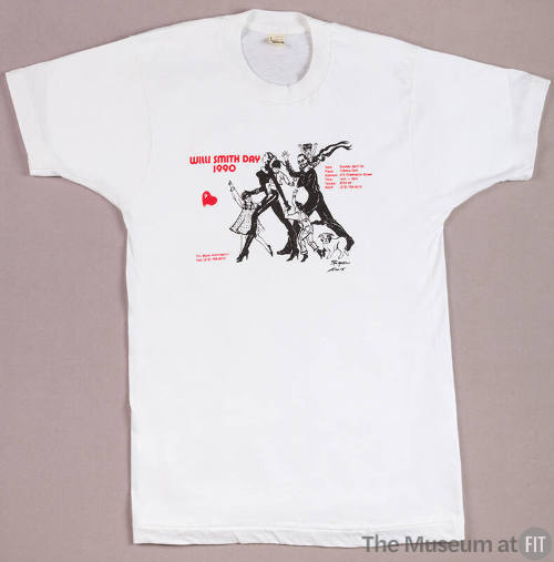 White short sleeve t-shirt printed in red Willie Smith Day 1990 and image of family with childr…