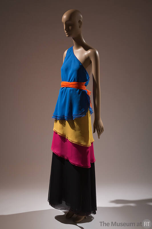 Blue, yellow, pink, black layered one shoulder floor length dress with orange belt