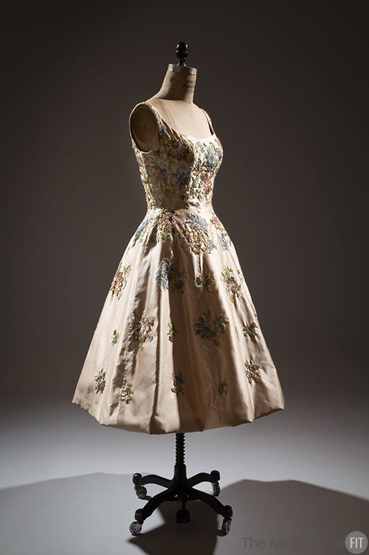 Off-white silk sleeveless dress with embroidered pink, green, blue and brown floral design, to-…