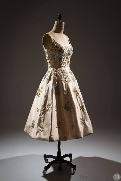 Off-white silk sleeveless dress with embroidered pink, green, blue and brown floral design, to-…