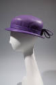 Purple leather hat with shallow brim and bow at back