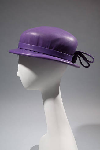 Purple leather hat with shallow brim and bow at back