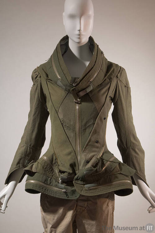Army green pieced jacket with oversize stand collar, sculpted peplum and front zipper closure w…