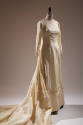 Off-white wedding gown with long sleeves and embroidered and appliqued flowers at round necklin…