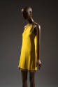 Bright yellow sleeveless evening mini dress with beaded trim at neckline, armholes, and hem wit…