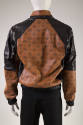 Back of oversized brown bomber style jacket with black MCM logo print and black shoulder panels…