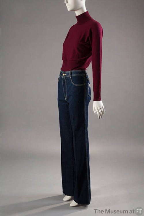 Dark red turtleneck sweater tucked into dark blue denim jeans with yellow topstitching 