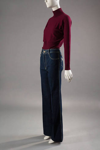 Dark red turtleneck sweater tucked into dark blue denim jeans with yellow topstitching 