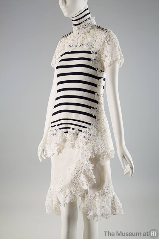 Lace trimmed white short sleeve turtleneck top with navy blue stripes and white knee length wra…