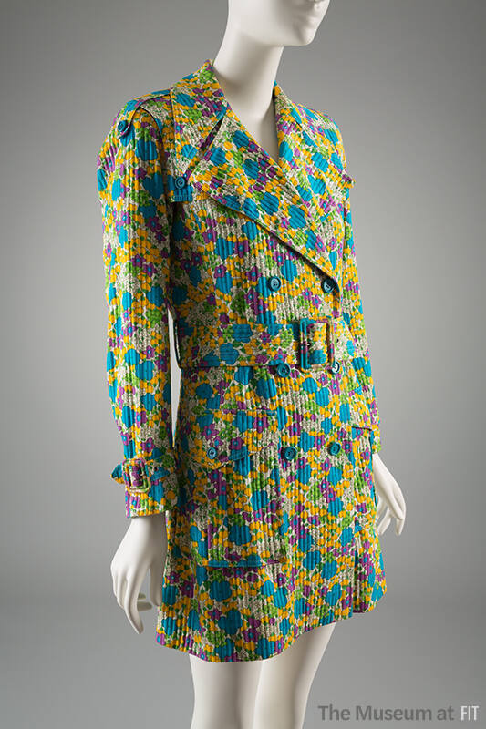 Trench coat in green, turquoise, yellow, purple and off-white floral print with oversize lapels…