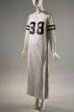 White long sleeve ankle length sequined dress with black number 38 on chest and two stripes aro…