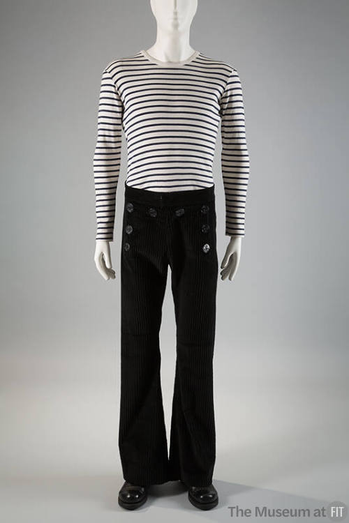 Man’s white and navy blue horizontal striped long sleeve top and black corduroy sailor style be…