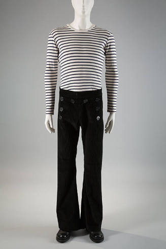 Man’s white and navy blue horizontal striped long sleeve top and black corduroy sailor style be…