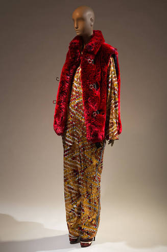 Yellow multicolor pattern long sleeve jumpsuit under open red faux fur vest with three loop clo…