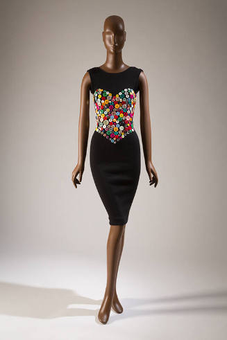 Black fitted sleeveless knee length dress with heart shaped bustier design made of various butt…