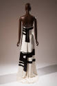 Back view of white strapless evening dress showing thick black brushwork motifs and slight skir…