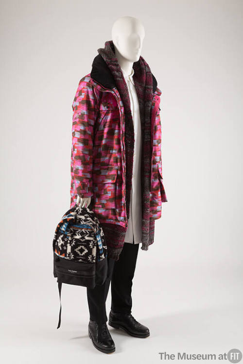 Man’s fuchsia abstract print parka, grey and red striped sweater, white dress shirt, black pant…