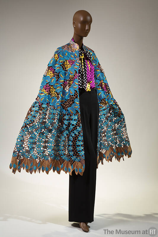 Blue and brown cotton and lace cape over black, white, purple and yellow polka dot blouse and b…