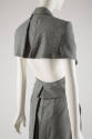 Detail view of teal and white suit showing back of jacket with open lower half and cape effect …