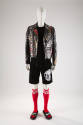 Man’s black leather jacket with graffiti paint, black top, black shorts with white skull appliq…