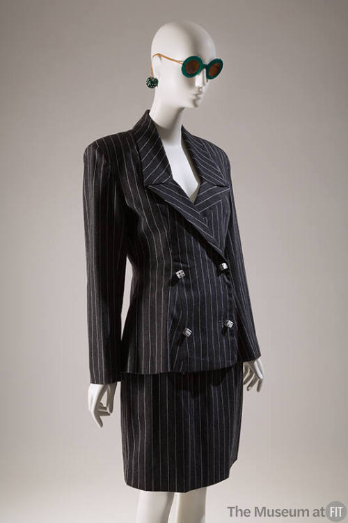 Grey pinstriped double breasted suit with dice shaped buttons, above the knee straight skirt an…