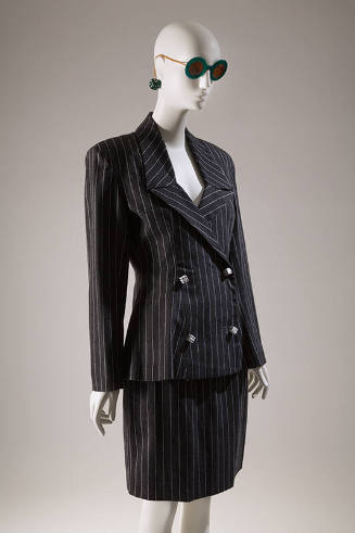 Grey pinstriped double breasted suit with dice shaped buttons, above the knee straight skirt an…