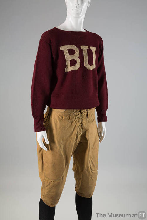 Man’s dark red sweater with white “BU” on center chest dressed with tan knee length football kn…