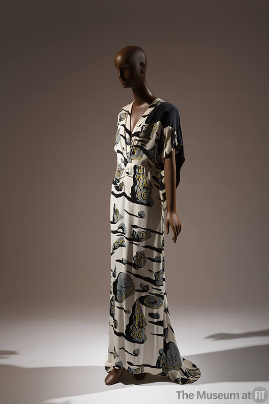 Off-white floor length dress printed with gray stones with black shadows and yellow symbols, V-…