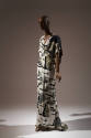 Off-white floor length dress printed with gray stones with black shadows and yellow symbols, V-…