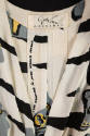 Interior detail of off-white dress bodice with grey, black, and yellow details and Adrian Origi…