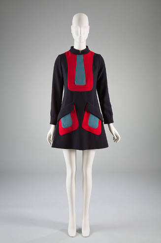 Navy blue A-line dress, with contrasting red U shaped inserts filled in with light blue and lon…