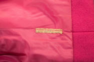 Detail view of label inside pink coat reading Warner Bros Pictures, Inc. L. Bacall