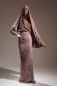 Light purple floor length evening sheath dress, left sleeve panel makes capelet covering the he…
