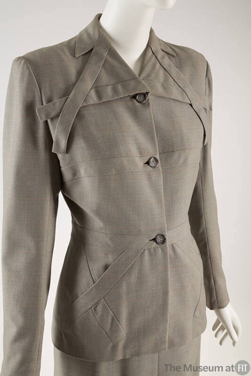 Gray / orange check jacket with overlapping decorative fabric strips