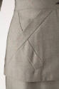 Gray / orange check jacket hip detail showing inset overlapping fabric strips
