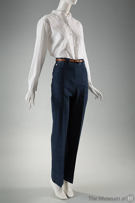 Blue denim jeans, creased at center leg, dressed with white buttoned shirt and brown belt
