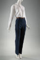 Blue denim jeans, creased at center leg, dressed with white buttoned shirt and brown belt